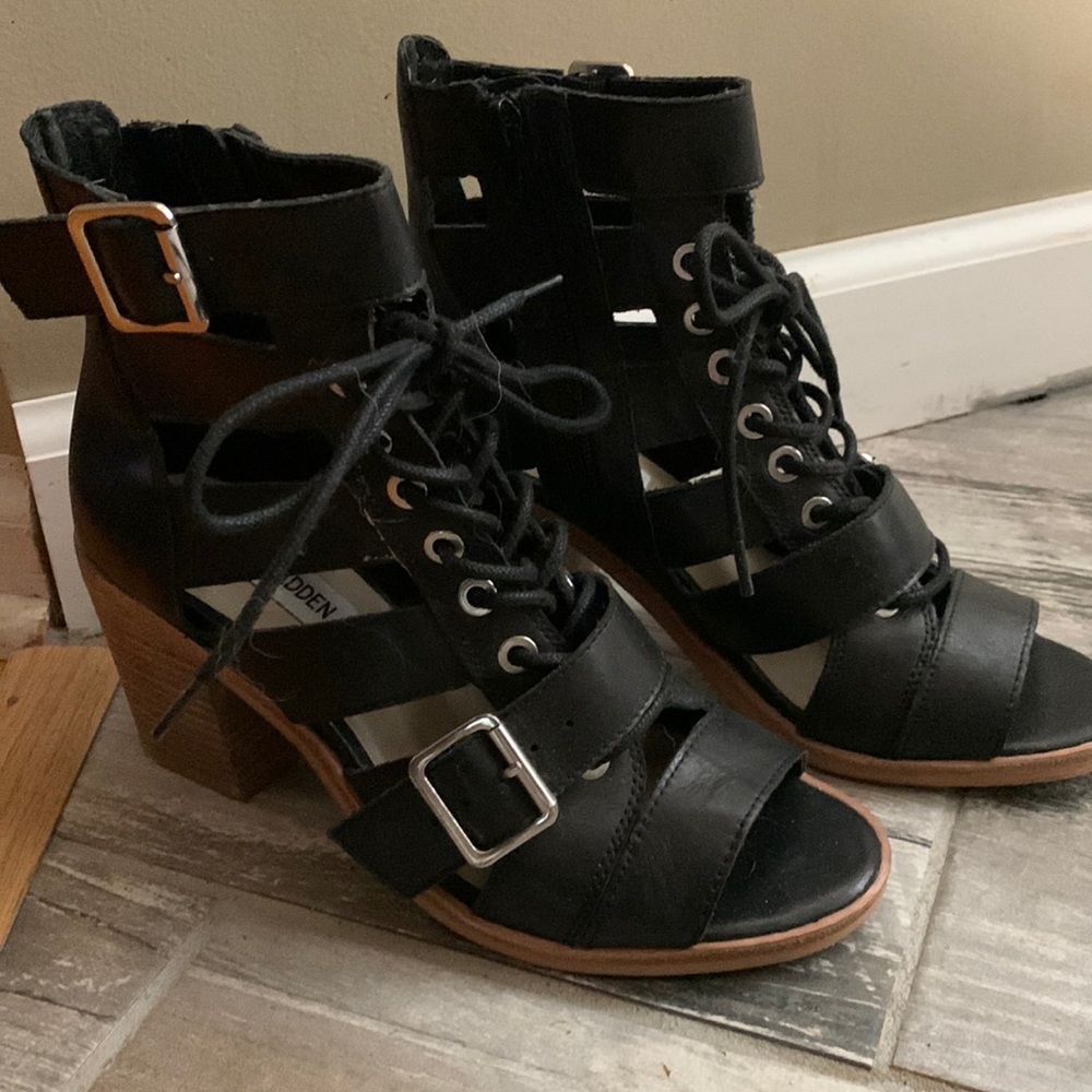 Leather with chunky wood heals. Worn once. Perfect condition.